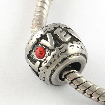 Bead with LOVE inscription and red surgical steel ring