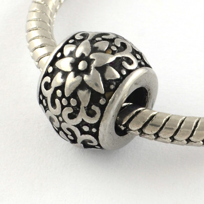 Bead with ornament in two color variants of surgical steel