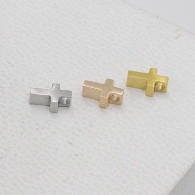 Small cross in three color variants made of surgical steel