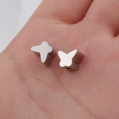 Bead with small bow tie in two colors of surgical steel