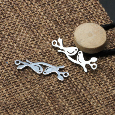 Connector birds sitting on a twig of surgical steel