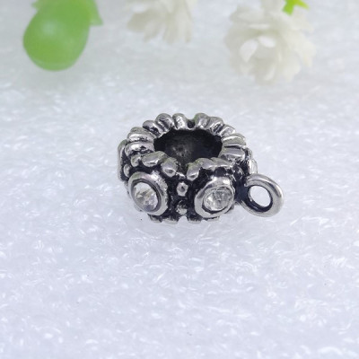 Bead with eyelet and chatons made of surgical steel