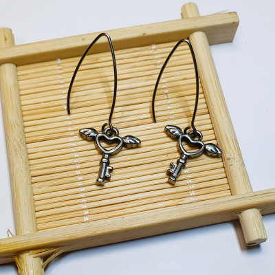 Dangle earrings with an angel's key, surgical steel