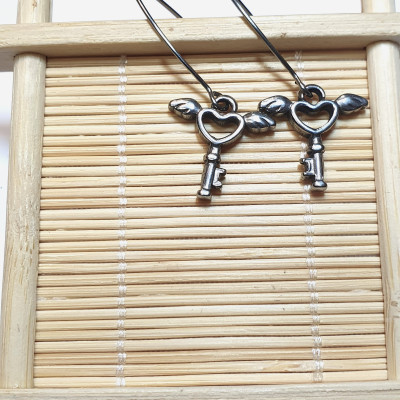 Dangle earrings with an angel's key, surgical steel