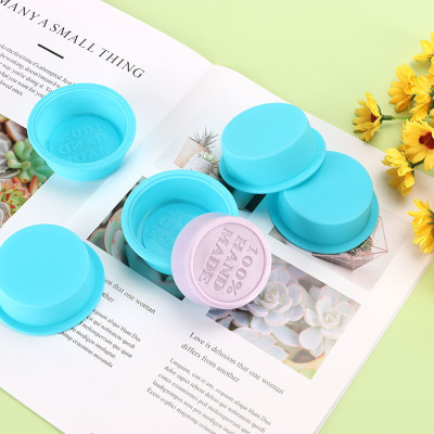 Round silicone mold for making soap with the inscription HAND MADE